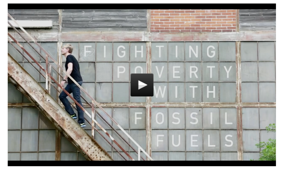 This GatesNotes video shows Lomborg climbing a rusty outdoor staircase against a brick and metal backdrop with the words "Fighting poverty with fossil fuels."