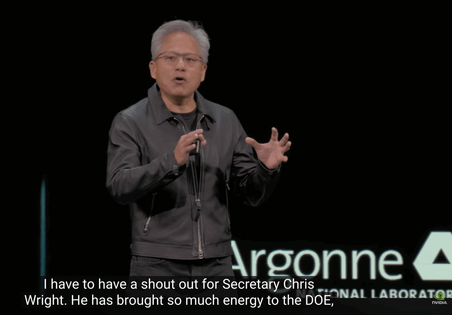 Video still of Nvidia CEO Jason Huang's keynote speech at an October AI conference. The English caption reads, "I have to have a shoutout for Secretary Chris Wright. He has brought so much energy to the DOE."