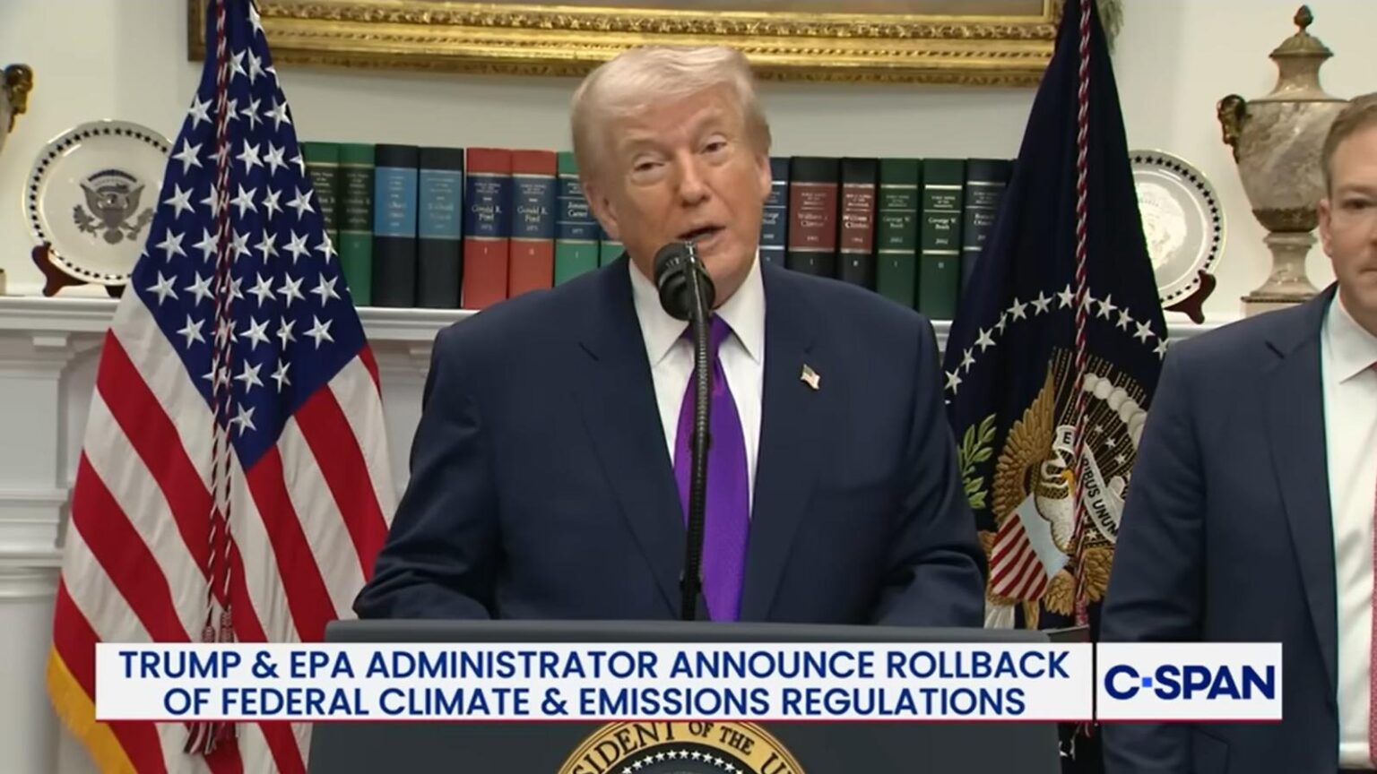 President Trump at a podium in front of books and flags announces the final repeal of the EPA Endangerment Finding. A C-SPAN banner at the bottom reads 'Trump and EPA Administrator announce rollback of federal climate and emissions regulations.'