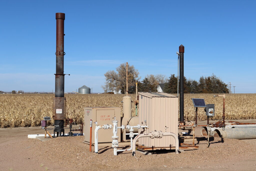 Oil and gas equipment in Weld County, Colorado, next to a cornfield where a gas well contamination remediation project is underway.