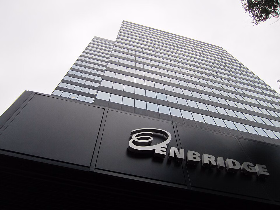 A tall gray office building with the Enbridge logo