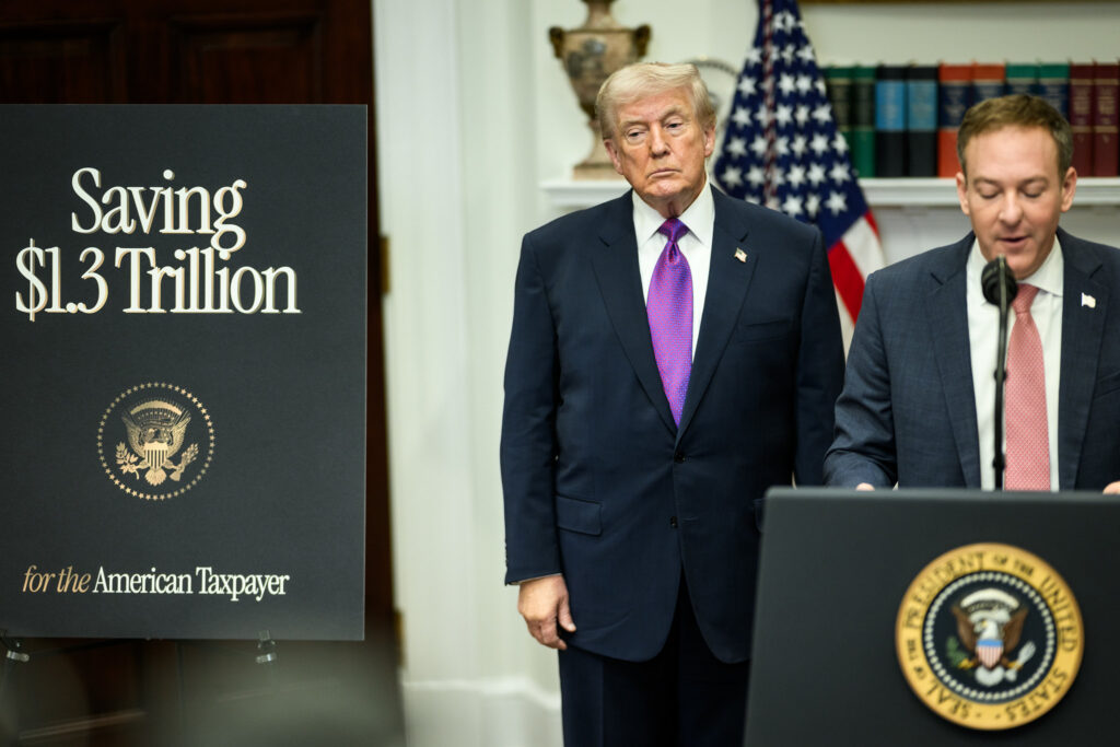President Donald Trump stands next to EPA Administrator Lee Zeldin in the White House. Left, a poster reads 'Saving $1.3 trillion for the American taxpayer.'