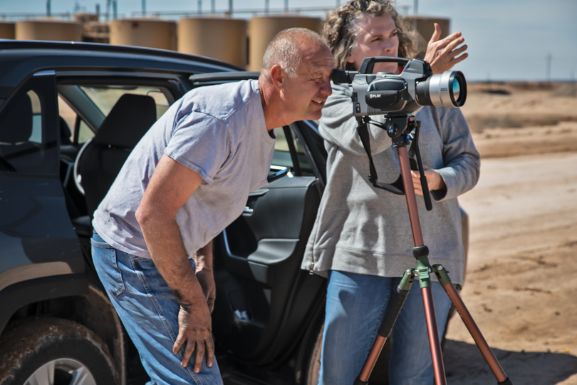 Sharon Wilson showing MDC senior lease operator Jeff Griffith a problem at an oilfield site on March 6, 2020.