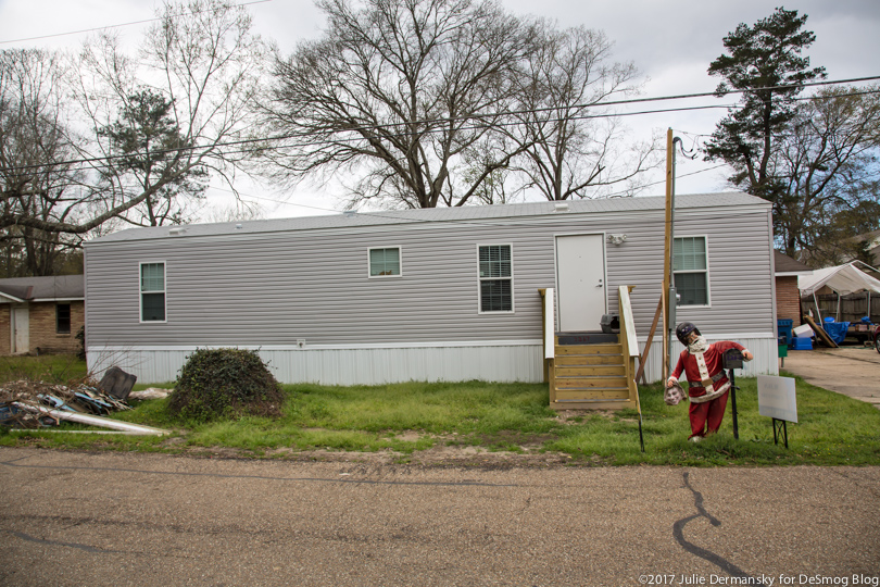 A trailer in front of a flood-damaged home in Louisiana.