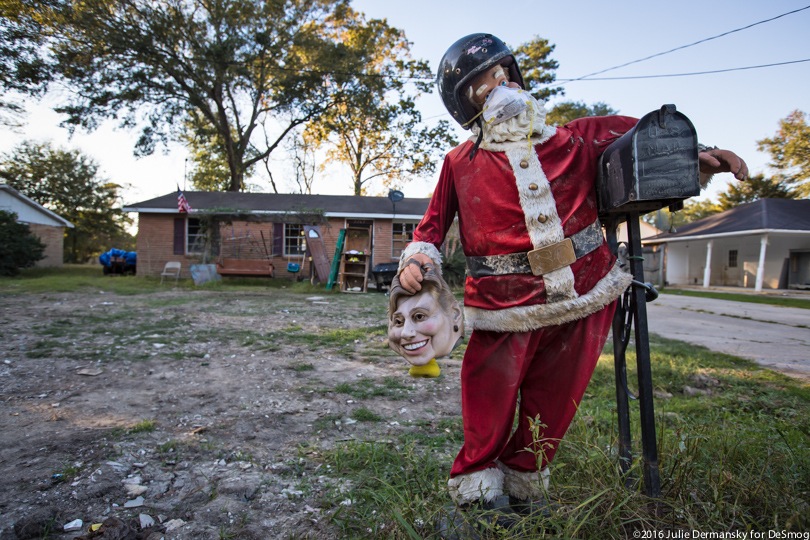 A life-sized Santa stands outside a flood-damaged house in Louisiana.