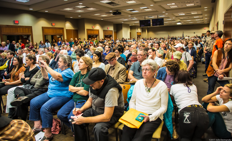 Full room of attendees at a public meeting for a permit hearing for Bayou Bridge pipeline