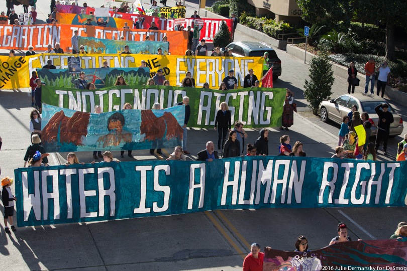 Protesters holding signs in solidarity with Standing Rock