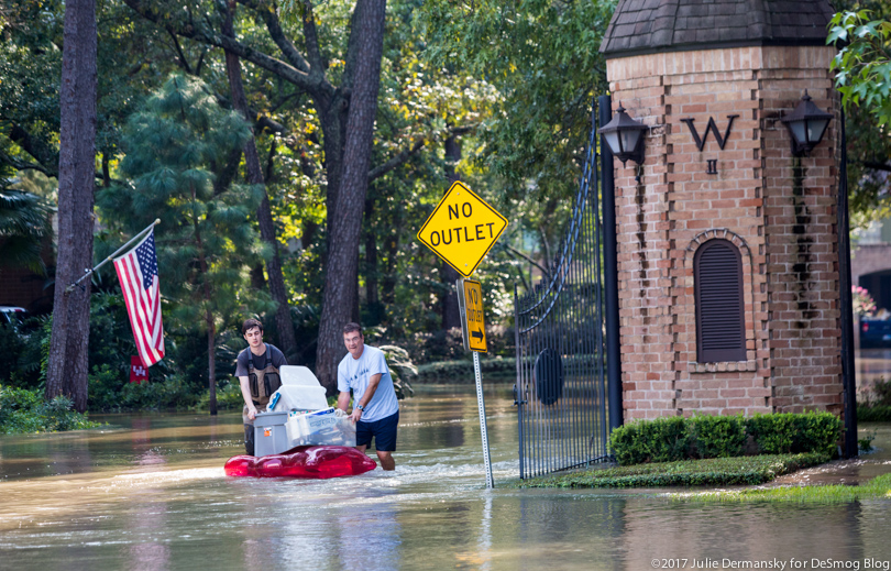 The Purcell family stack belongings on a raft in the shin-high floodwaters