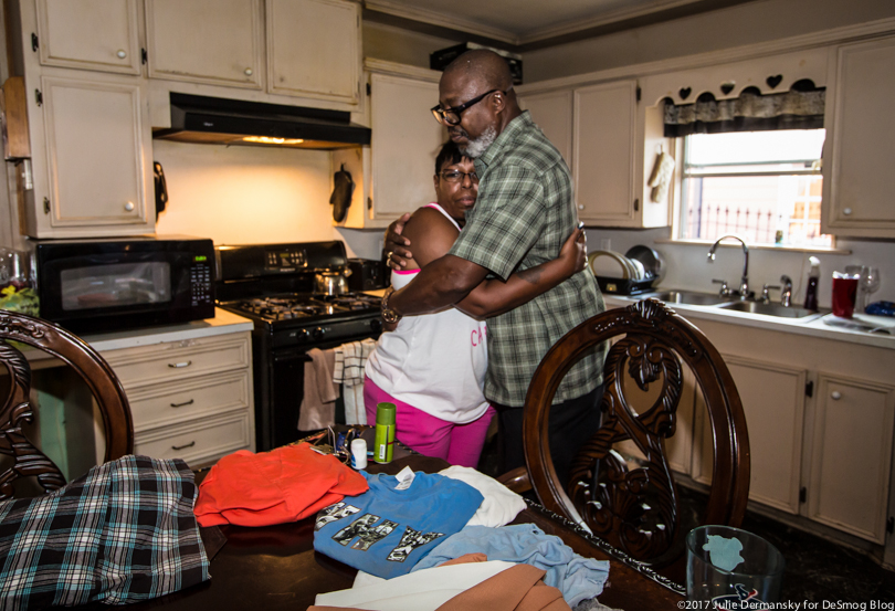 Hilton and Marie Kelley hug in their flood-damaged kitchen