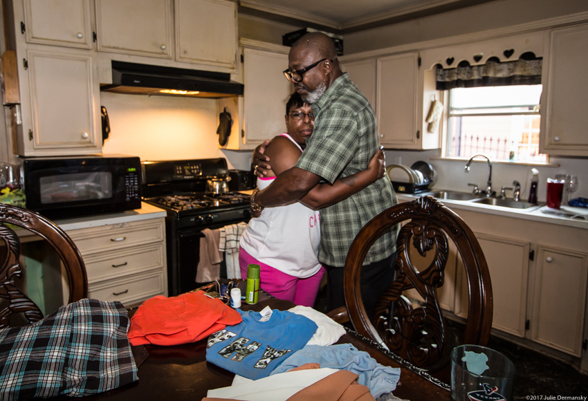 Environmental justice advocate Hilton Kelley and his wife Marie embrace in their flood-damaged kitchen after Hurricane Harvey