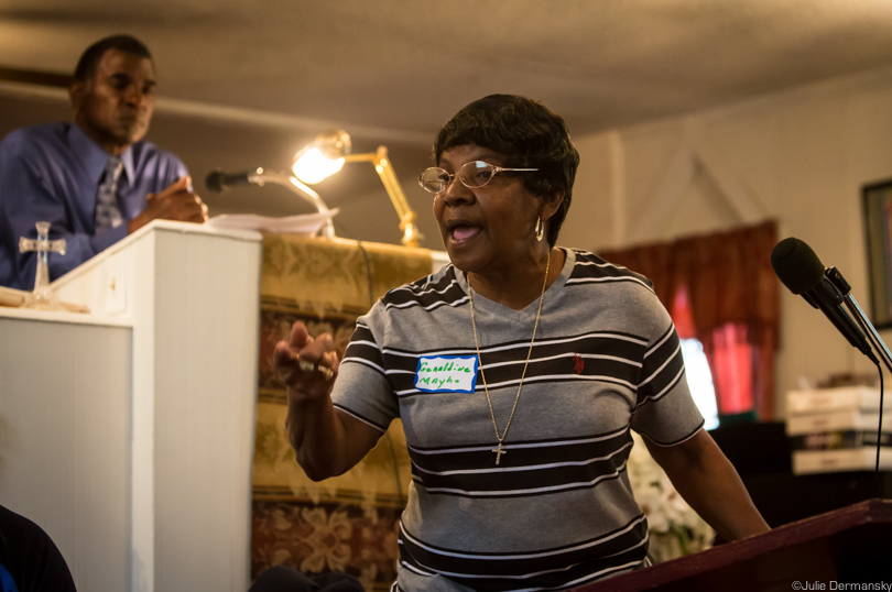 Geraldine Mayho shares her story at a Mt. Triumph Baptist Church community meeting.