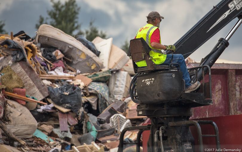 A worker at the temporary dump for hurricane debris in Port Arthur