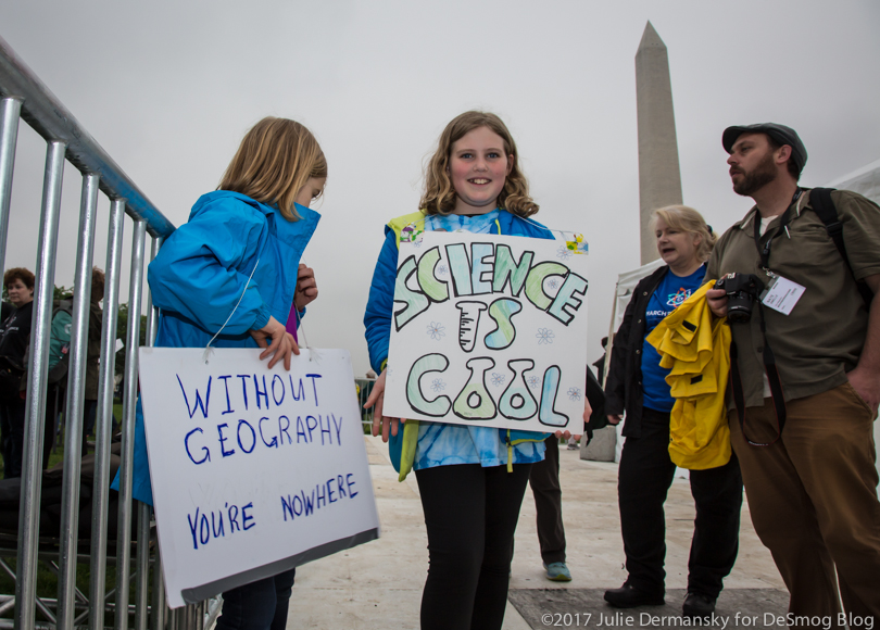 Elise Filipowicz and her family hold signs at the science teach-ins.