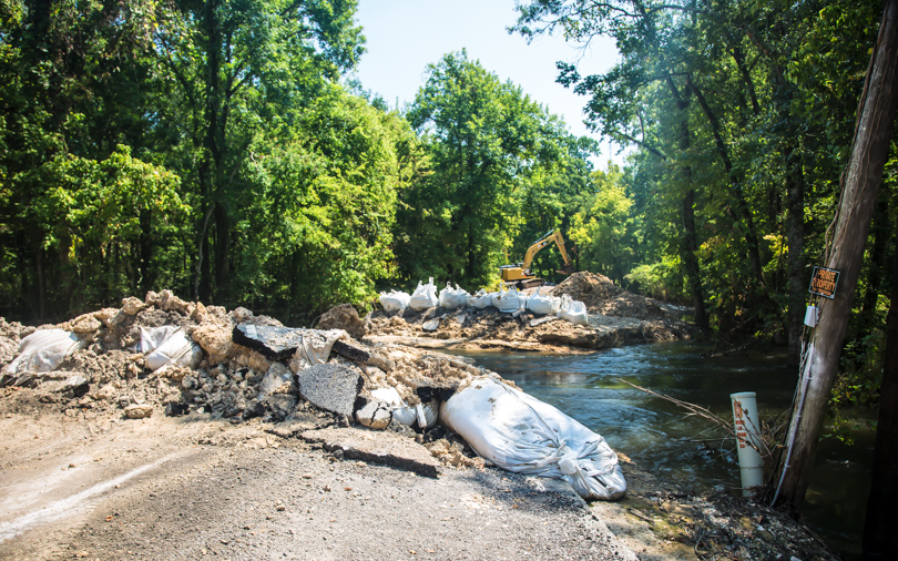 Local officials made a cut in Alligator Bayou Road so floodwater could escape from the Spanish Lake Basin in southern Louisiana.