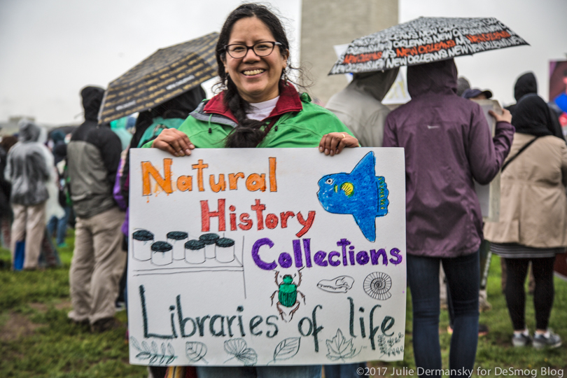 Fish scientist Norma Salcedo holds her sign supporting natural history collections