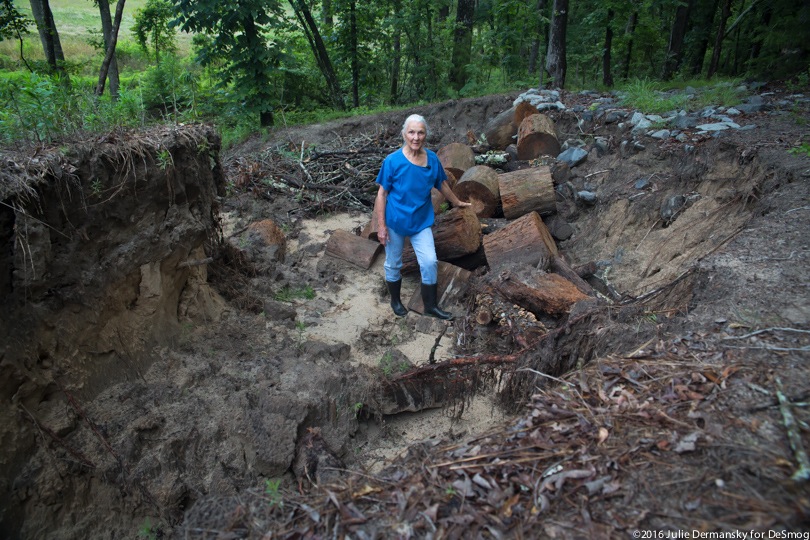 Eleanor Fairchild stands in a ditch on her property created by TransCanada's pipeline construction