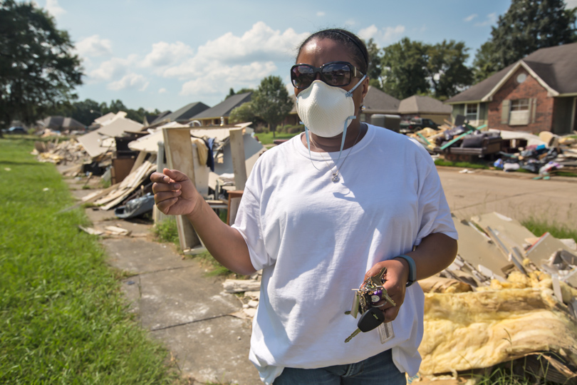 Robin Kay in front of her home in Monticello, Louisiana. She thinks the recently completed Central Thruway roadway project contributed to the severity of the August flood. 