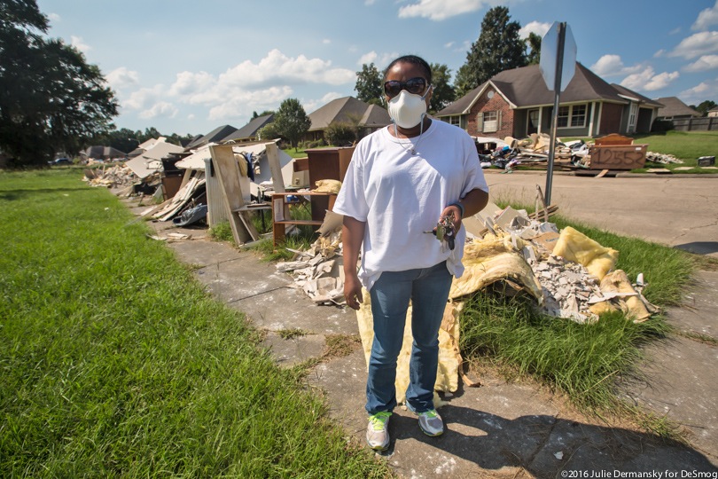 Robin Kay in front of her flood-damaged home in Louisiana.