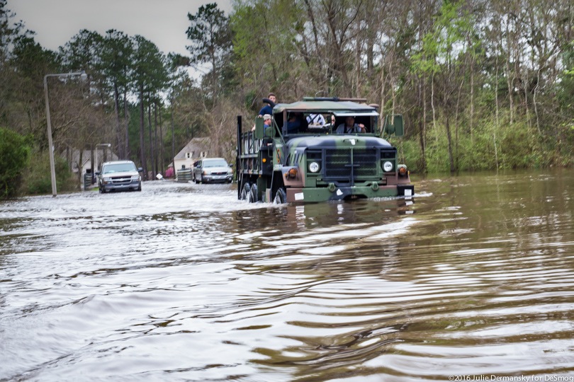 A Louisiana National Guard truck drives through floodwaters