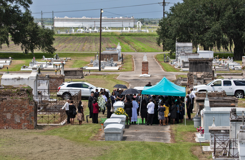Geraldine Mayho's body was laid to rest in the St. James Catholic cemetery across from oil storage tanks.
