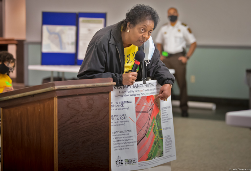 Sharon Lavigne holding a poster and testifying at a methanol plant permit hearing