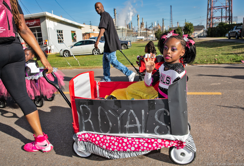 Children in wagons pass a Shell refinery in Norco, Louisiana, during the annual Christmas Parade.