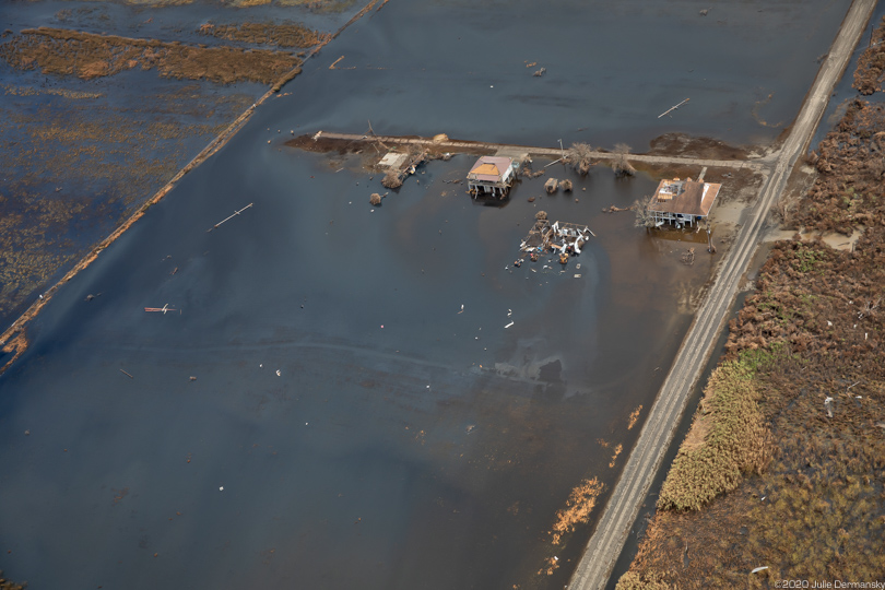 Oil in floodwaters around homes in Cameron Parish, Louisiana, after Hurricane Laura