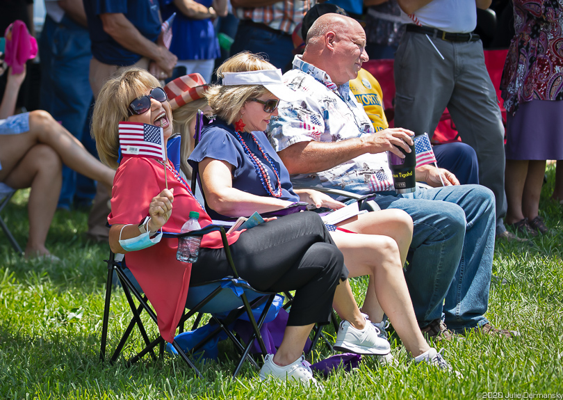 Woman with a mask on her arm at the "save America" July 4 rally