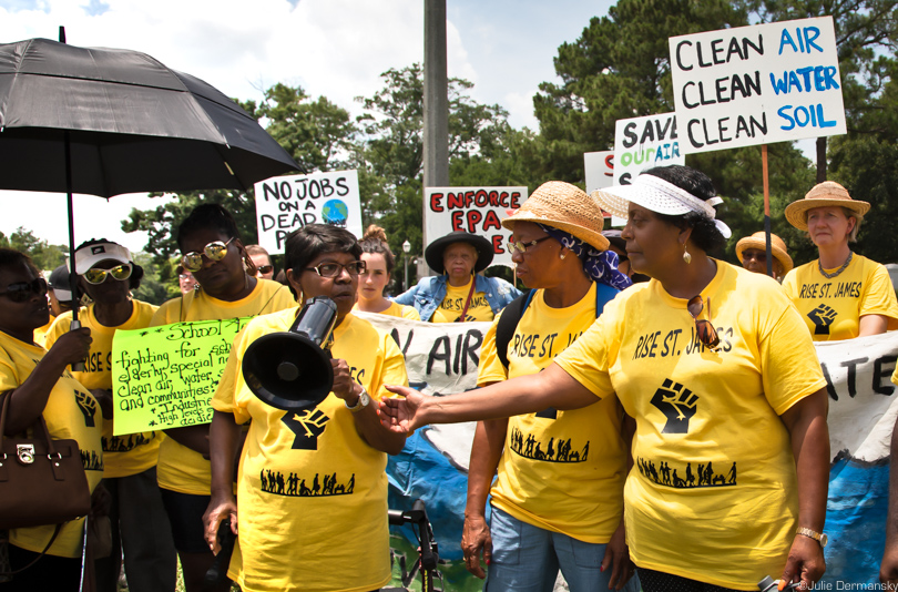 Geraldine Mayho with a megaphone in front of the Louisiana Governor's Mansion in Baton Rouge