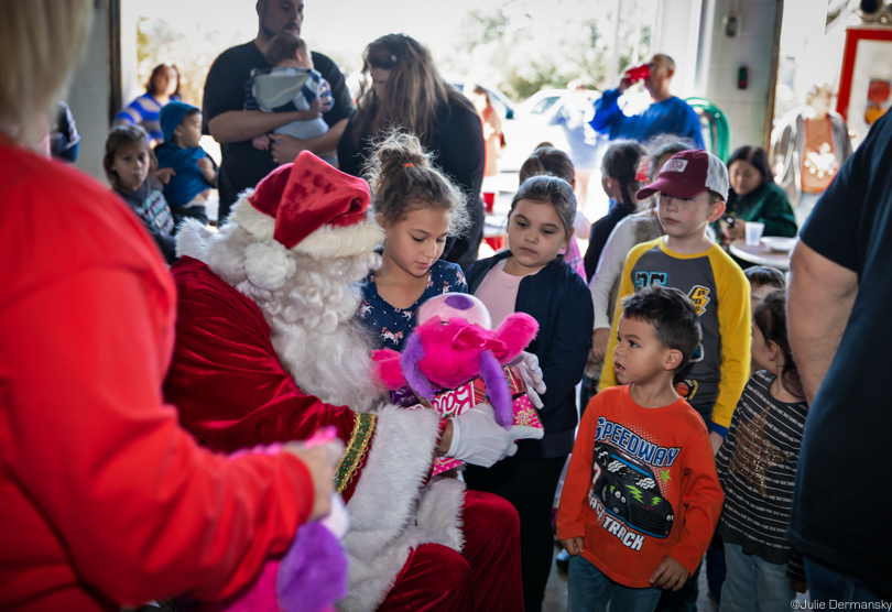 Kids gather around Santa at the IDJC Tribe's Christmas gathering.