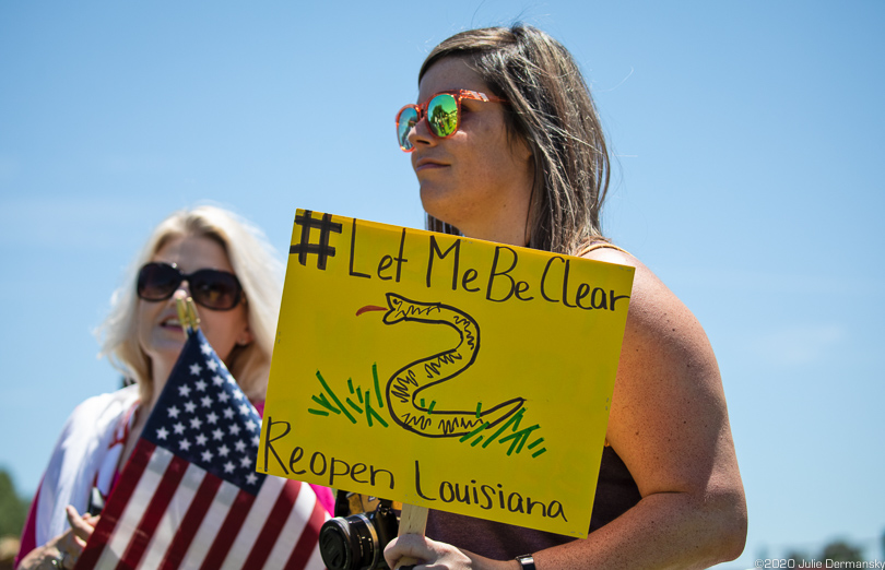 Protester across from the Governor’s Mansion on May 2 with a protest sign that is a variation of the Gandsen Flag. 