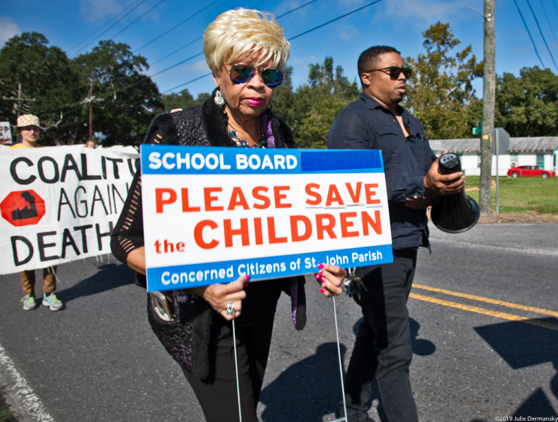Concerned Citizens of St. John march from an elementary school to the Denka plant
