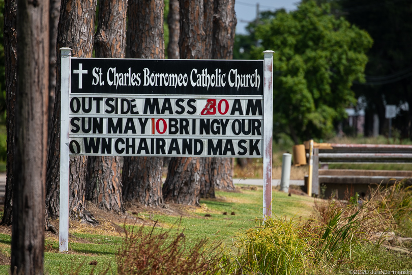 Sign about outdoor services at the church Chief Naquin attends in Montegut, Louisiana