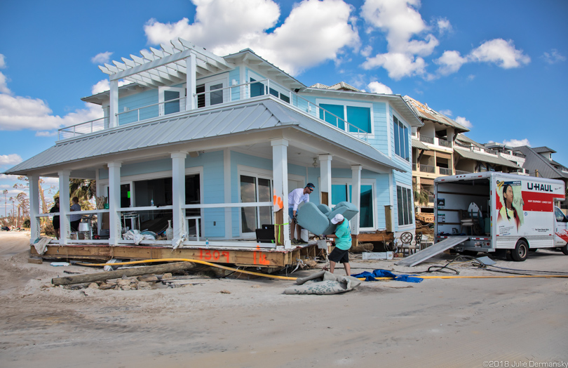 Owners of a home built to code in Mexico Beach retrieve belongings from top two stories on the beach.