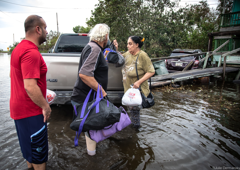 Edison and Elizabeth Dardar with their son Robert heading home amid floodwaters
