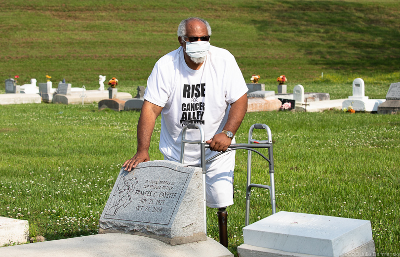 Milton Cayette, Jr. at his parents' grave in St. James, Louisiana