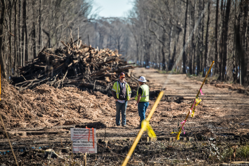 Construction workers standing at the site being cleared for the Bayou Bridge pipeline