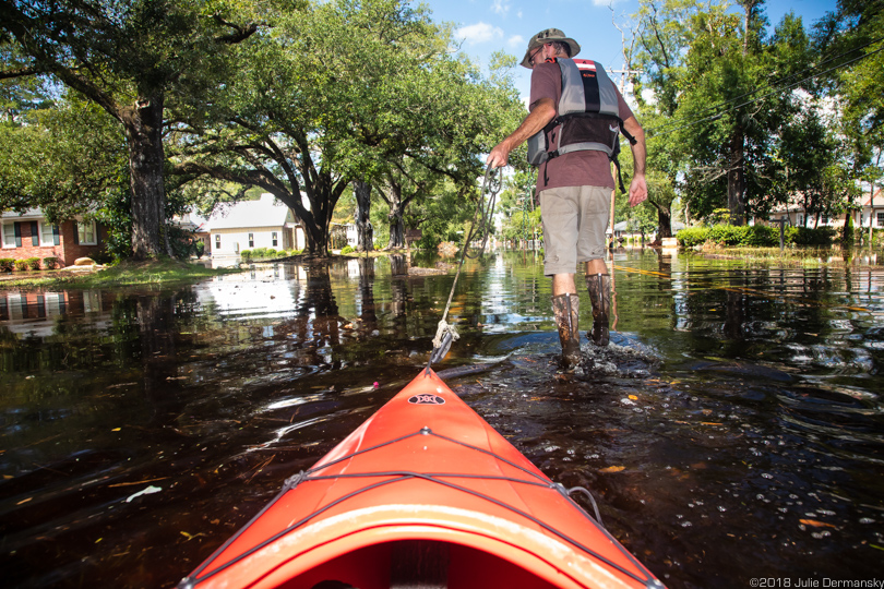 Chris Ochsenbein pulls a kayak into floodwaters in Conway, South Carolina