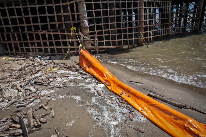 Containment boom left behind when a cleanup crew stopped work removing nurdles from a Mississippi River bank in New Orleans