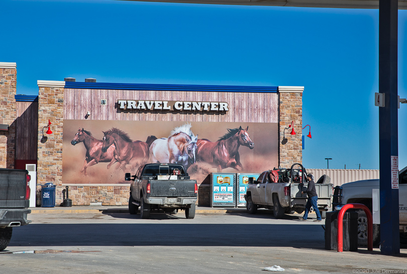 Ad glorifying American West at truck stop in Pecos, TX
