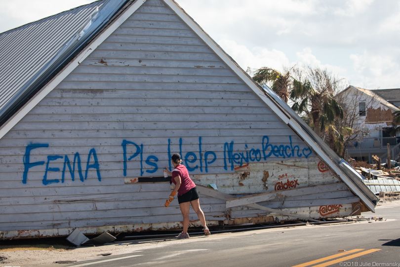 Woman spray-paints a message to FEMA asking for help after Hurricane Michael