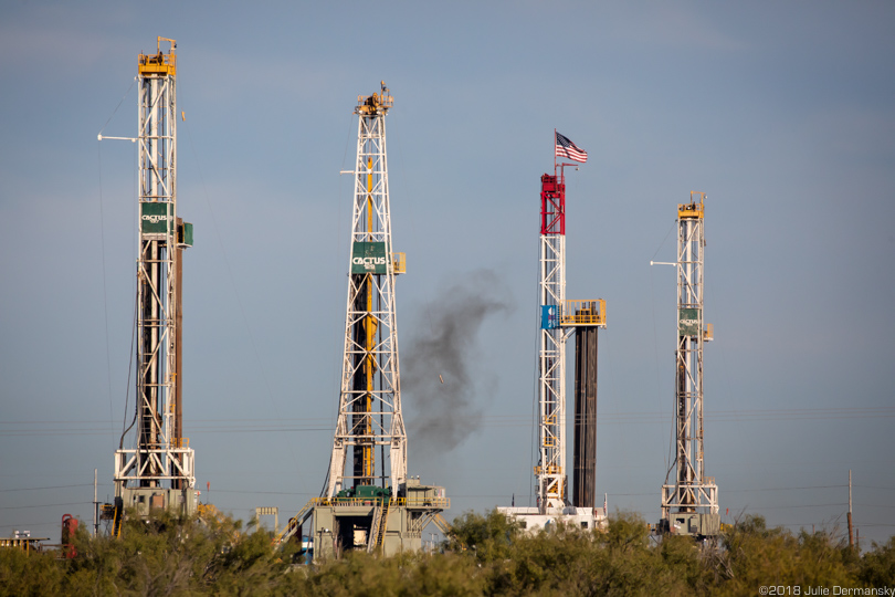 Four drilling rigs off the highway in Midland, Texas