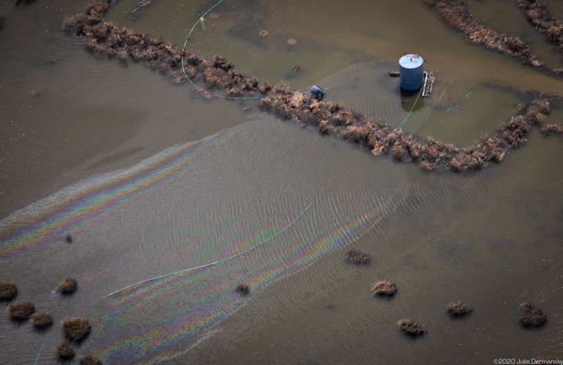Oil sheen near a tank spreading in Hurricane Laura floodwaters in Cameron Parish, Louisiana