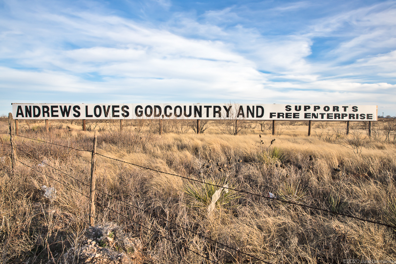Welcome sign in Andrews, Texas, reading 'Andrews loves God, country, and supports free enterprise'