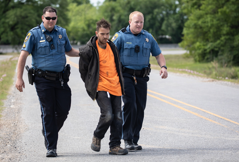 Protester escorted by two officers