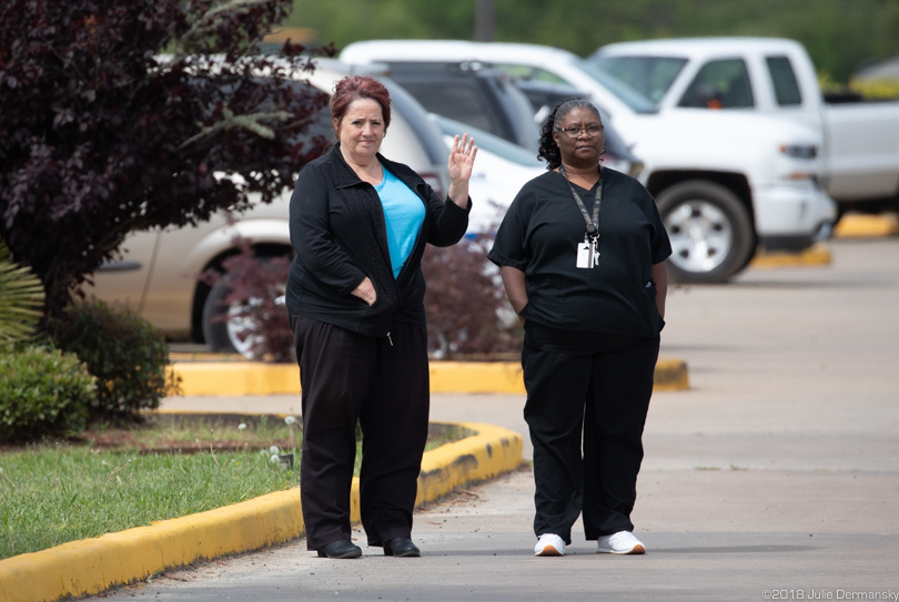 Hotel manager and staff wave goodbye to protesters