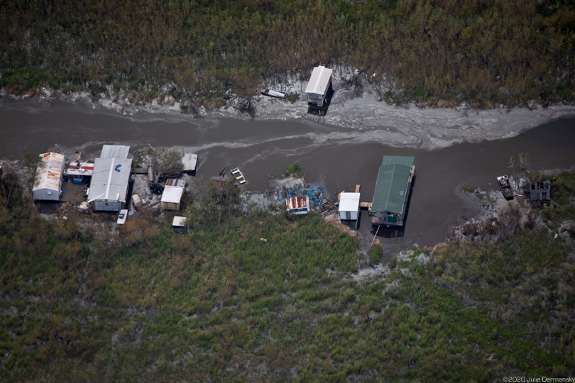 Oil sheen in a bayou and along homes in Cameron Parish.