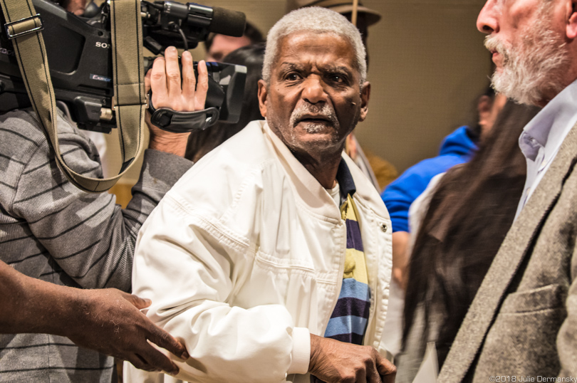 Larry J. Morgan being led away from the podium