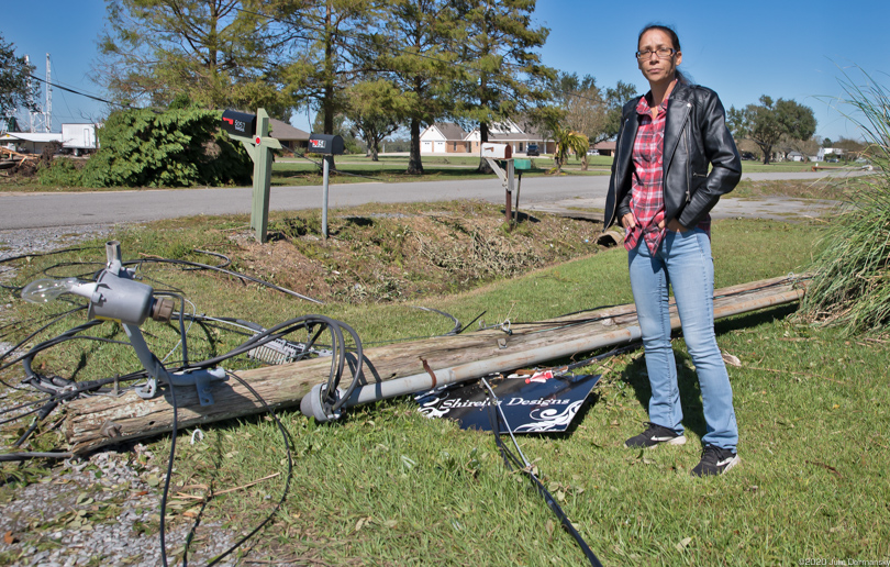 Chief Shirell Parfait-Dardar stands next to a downed power line in her driveway in Chauvin, Louisiana, after Hurricane Zeta.