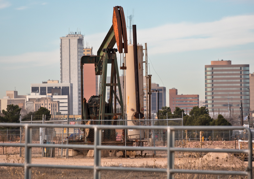 Skyline of Midland behind an oil pumpjack